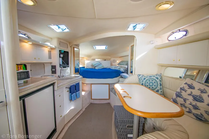 Slide: The Image of Interior of 1999 Sea Ray 340 Sundancer yacht with cozy seating and kitchenette. - 9