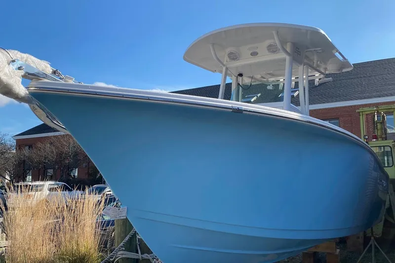 Slide: The Image of 2024 Sea Pro 242 boat with blue hull and T-top on display. - 3