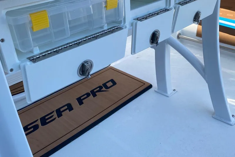 Slide: The Image of 2024 Sea Pro 242 boat storage compartments and branded mat. - 9