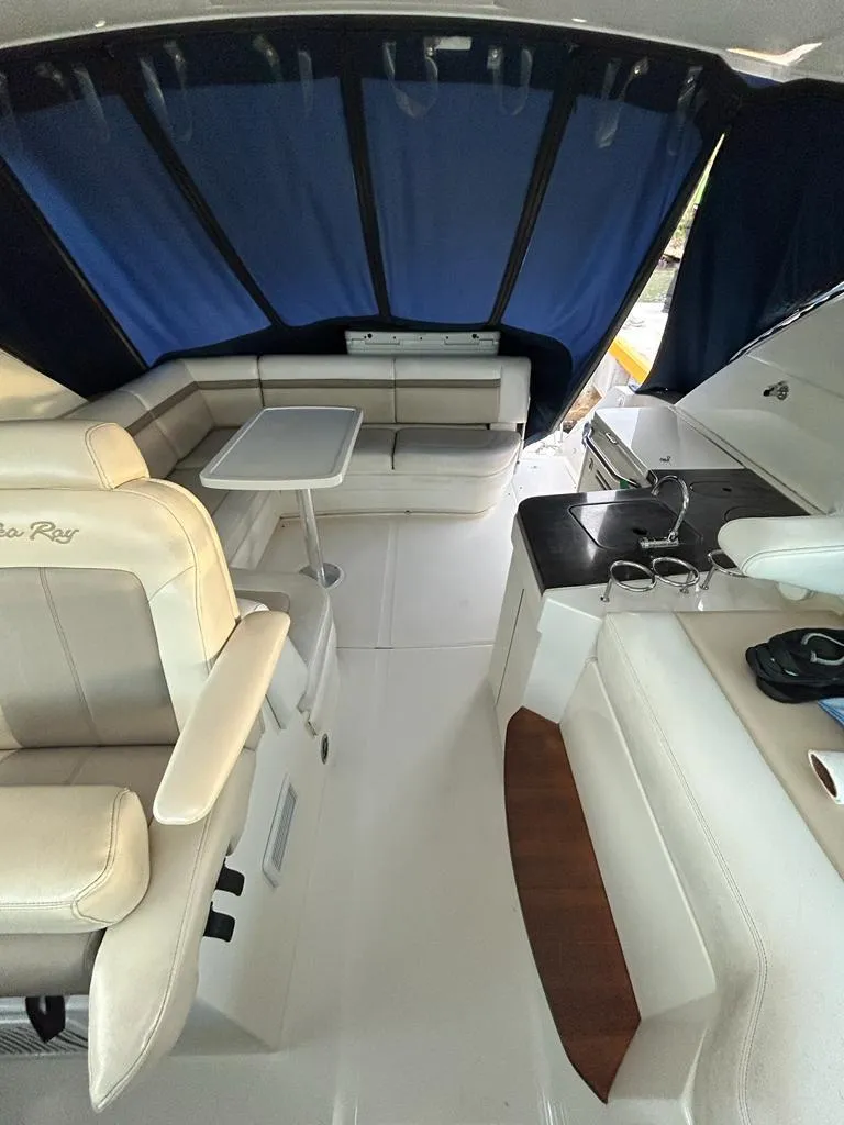 Slide: The Image of Interior of 2013 Sea Ray 410 Sundancer yacht with seating and kitchenette. - 4