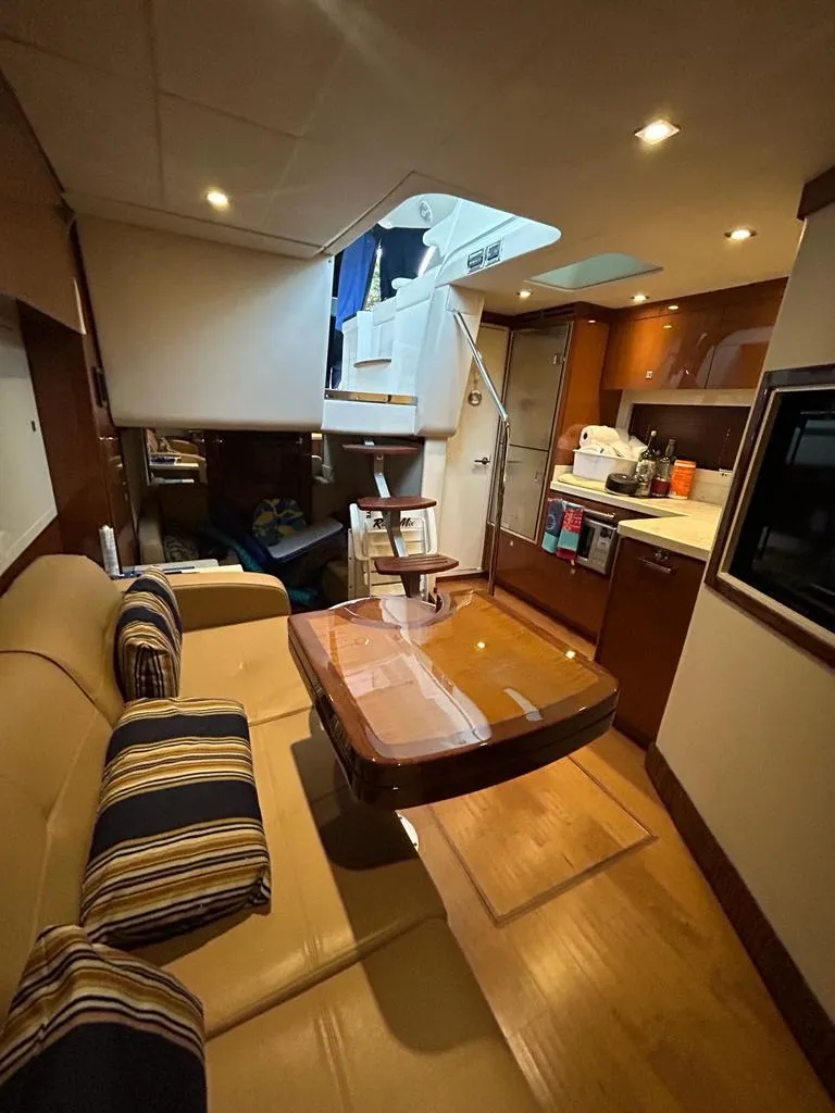 Slide: The Image of Interior of 2013 Sea Ray 410 Sundancer yacht with modern kitchen and cozy seating area. - 7