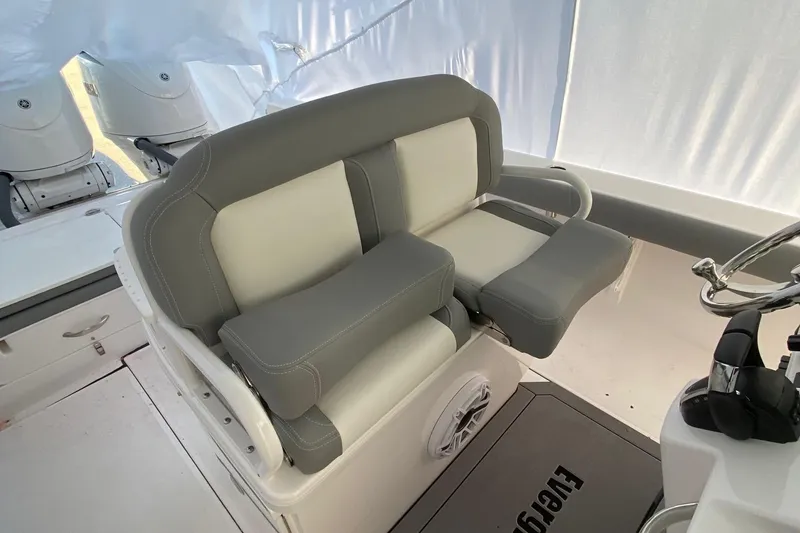 Slide: The Image of 2023 Everglades 273 boat interior seating with gray and white cushioned seats. - 2