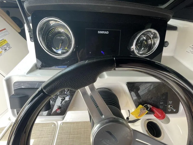 Slide: The Image of 2021 Sea Ray 210 SPX OB dashboard with steering wheel and Simrad display. - 3