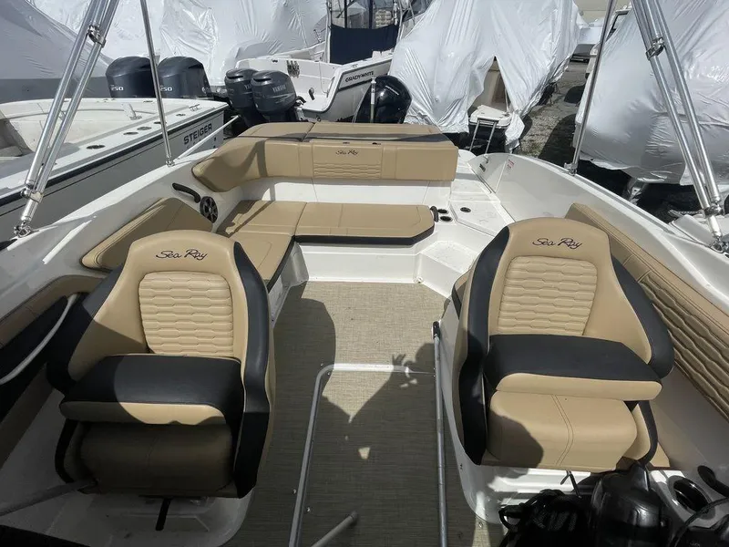 Slide: The Image of 2021 Sea Ray 210 SPX OB boat interior with tan and black seating. - 5