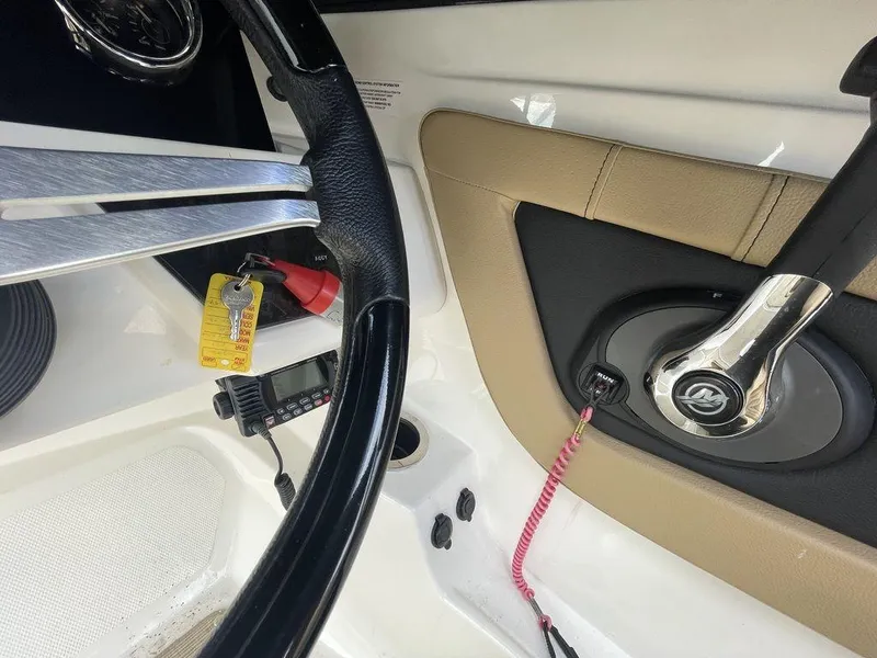 Slide: The Image of 2021 Sea Ray 210 SPX OB boat steering wheel and throttle control. - 7
