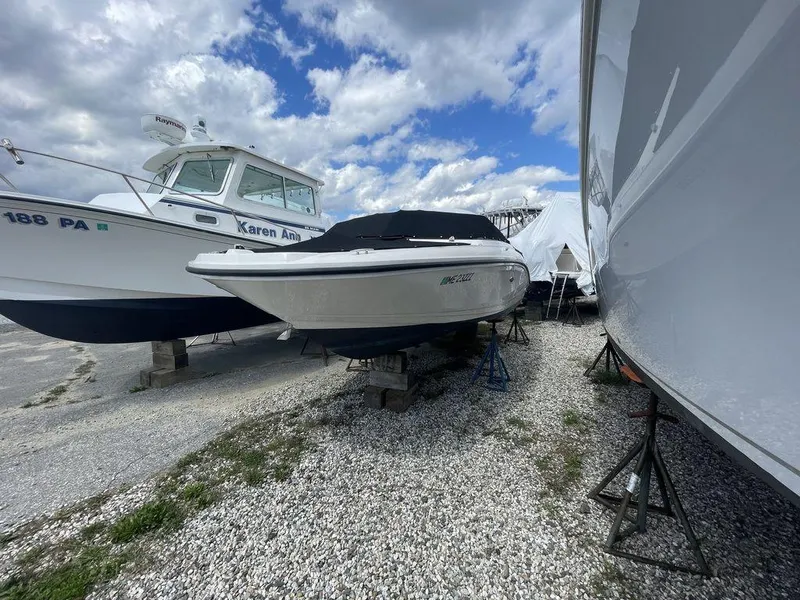 Slide: The Image of 2021 Sea Ray 210 SPX OB boat in storage, covered and elevated on stands. - 9