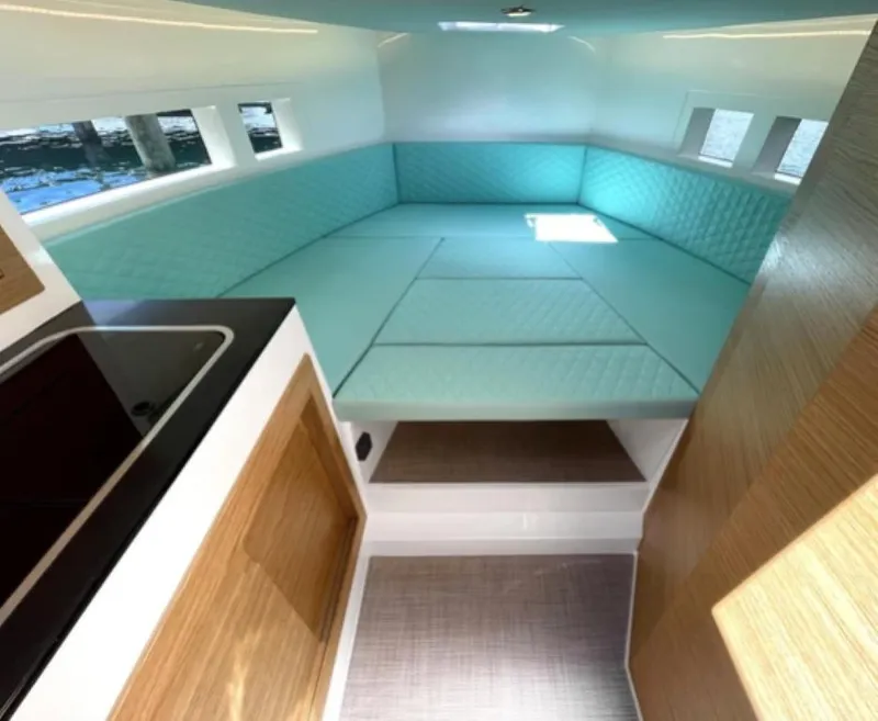 Slide: The Image of Interior of 2024 De Antonio Yachts D28 Cruiser with turquoise seating and modern design. - 4