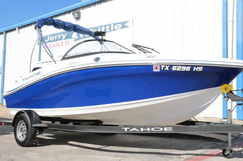 Slide: The Image of 2020 Tahoe 450 TS boat in blue and white on a trailer. - 0