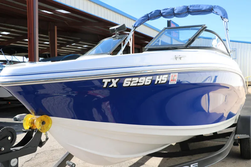 Slide: The Image of 2020 Tahoe 450 TS boat in blue and white on a trailer. - 10