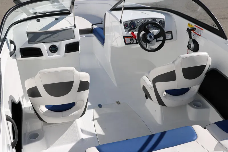 Slide: The Image of 2020 Tahoe 450 TS boat interior with steering wheel and seating. - 13