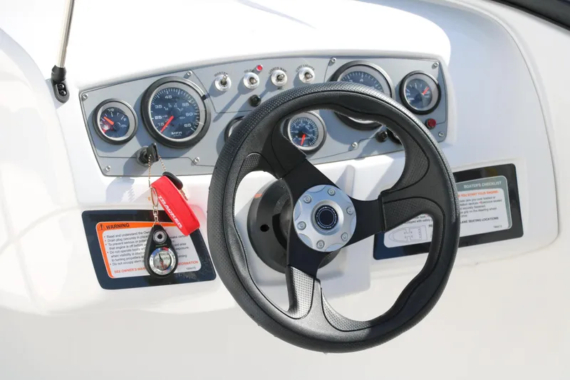 Slide: The Image of Steering wheel and dashboard of a 2020 Tahoe 450 TS boat. - 15