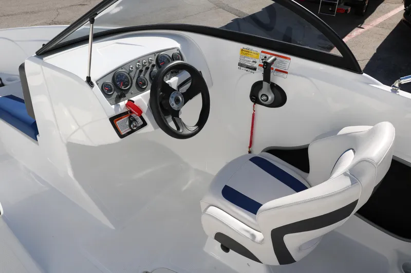 Slide: The Image of 2020 Tahoe 450 TS boat cockpit with steering wheel and captain's chair. - 20