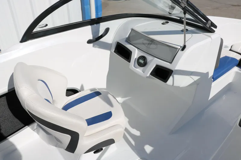 Slide: The Image of 2020 Tahoe 450 TS boat cockpit with white and blue captain's chair. - 26