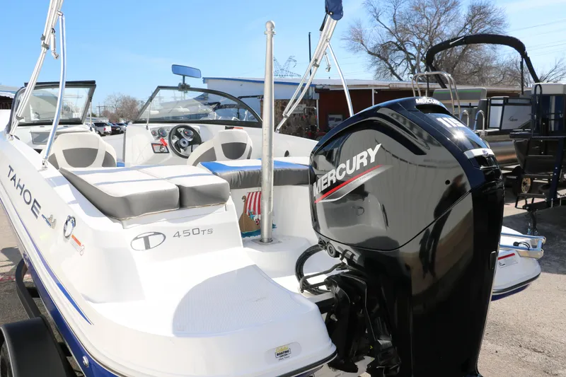 Slide: The Image of 2020 Tahoe 450 TS boat with Mercury outboard motor in a marina. - 29
