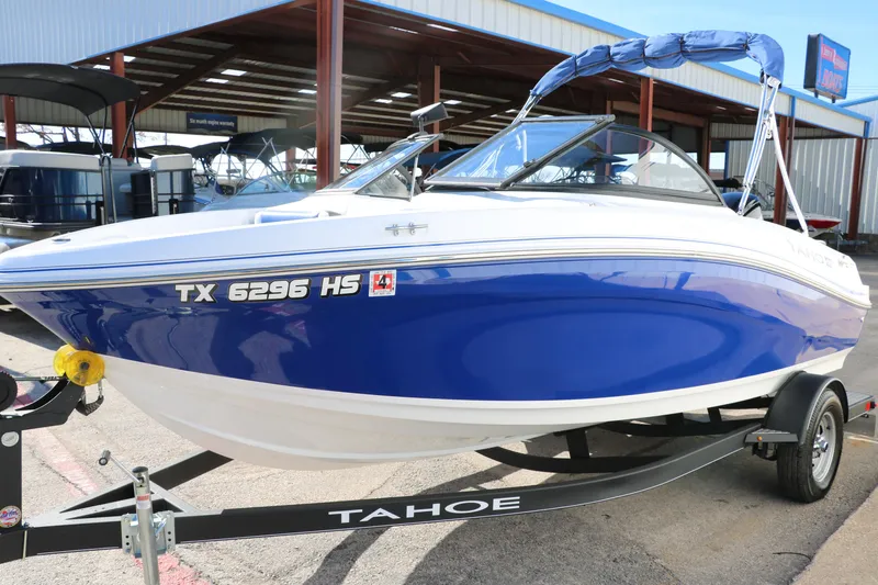 Slide: The Image of 2020 Tahoe 450 TS blue and white speedboat on trailer. - 8