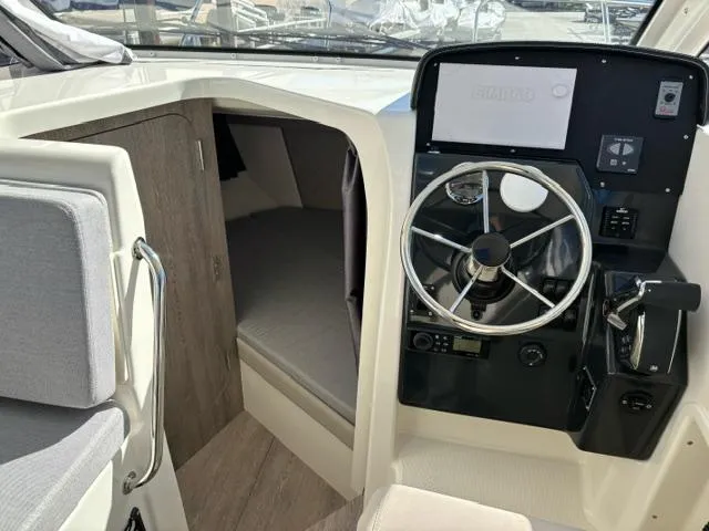 Slide: The Image of 2024 Bayliner TROPHY 25 EXPLORER cabin and helm station interior. - 12