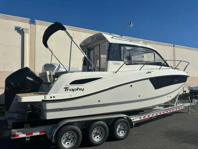 Slide: The Image of 2024 Bayliner TROPHY 25 EXPLORER boat on a trailer, side view. - 2