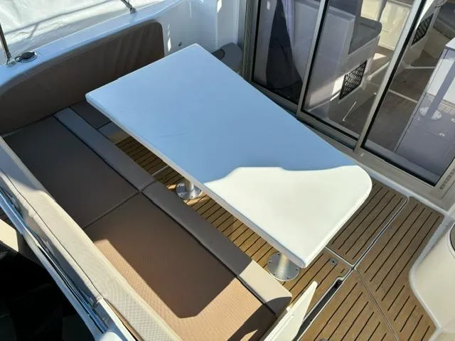 Slide: The Image of Bayliner TROPHY 25 EXPLORER 2024 boat interior with seating and table. - 27