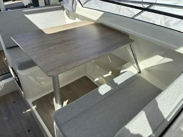 Slide: The Image of Interior seating area of 2024 Bayliner TROPHY 25 EXPLORER with wooden table. - 30