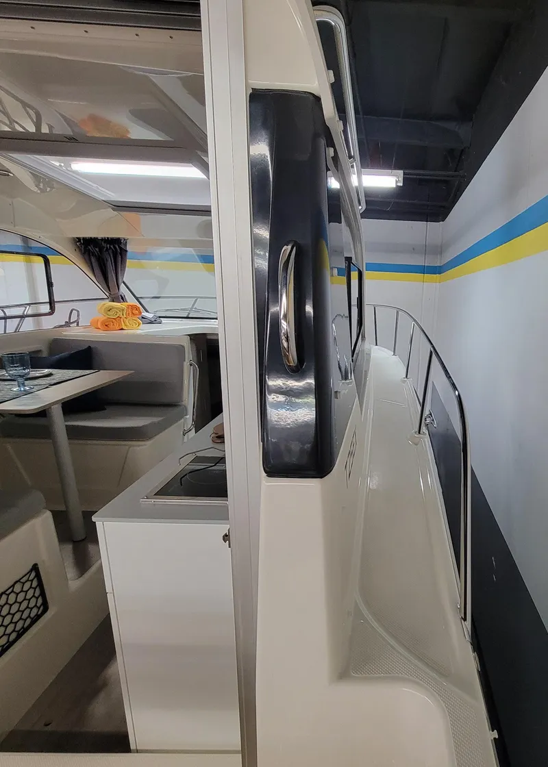 Slide: The Image of 2024 Bayliner TROPHY 25 EXPLORER interior view with dining area and side deck. - 42