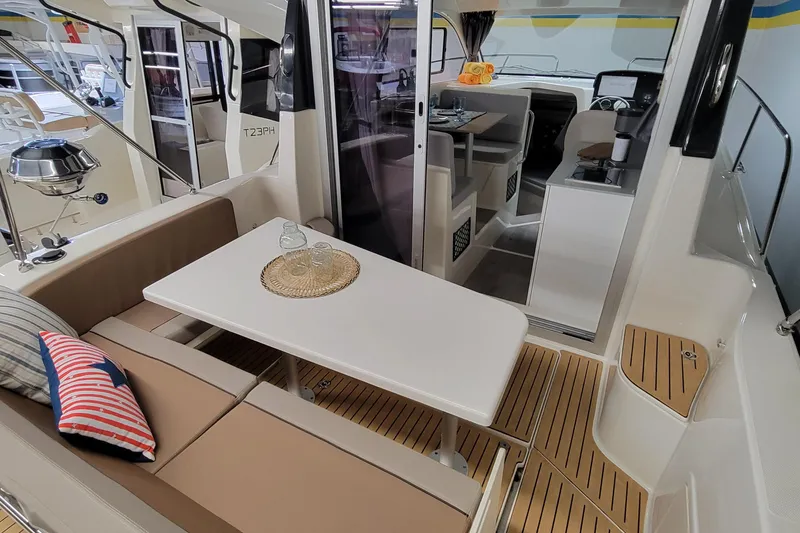 Slide: The Image of 2024 Bayliner TROPHY 25 EXPLORER interior with seating area and table. - 43