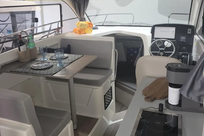 Slide: The Image of 2024 Bayliner TROPHY 25 EXPLORER interior with dining area, helm, and cabin. - 44