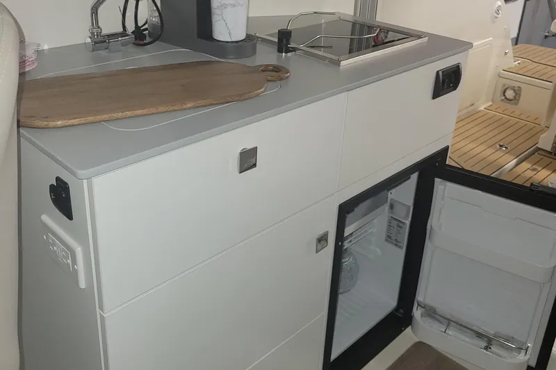 Slide: The Image of Compact kitchen area in the 2024 Bayliner TROPHY 25 EXPLORER boat. - 45