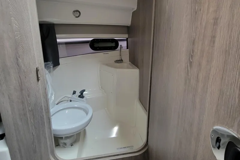Slide: The Image of 2024 Bayliner TROPHY 25 EXPLORER boat bathroom with toilet and sink. - 48