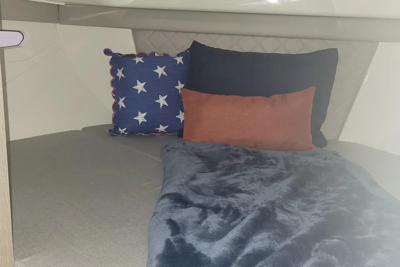 Slide: The Image of Cozy cabin interior of 2024 Bayliner TROPHY 25 EXPLORER with star-themed pillows. - 49