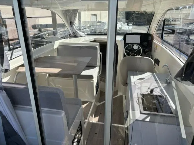 Slide: The Image of Interior of 2024 Bayliner TROPHY 25 EXPLORER boat with dining area and kitchenette. - 6