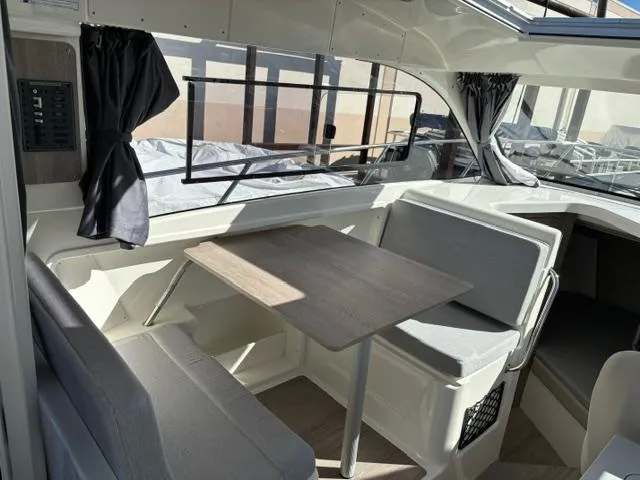 Slide: The Image of 2024 Bayliner TROPHY 25 EXPLORER cabin interior with dining table and seating. - 8