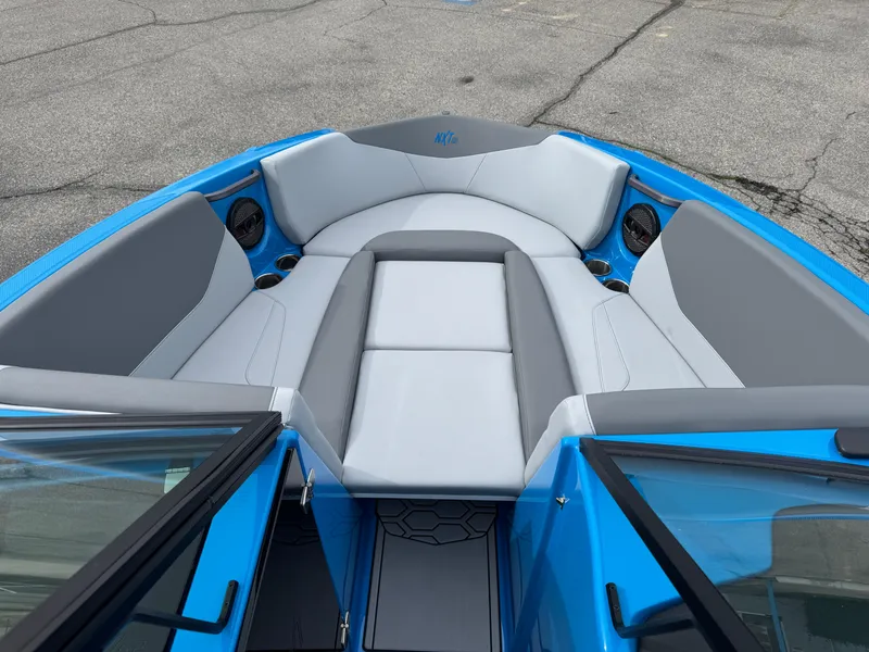 Slide: The Image of 2024 MasterCraft NXT23 boat interior with gray and blue seating. - 12