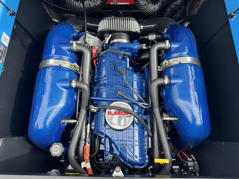Slide: The Image of 2024 MasterCraft NXT23 engine, featuring Ilmor components, with blue accents and advanced design. - 14