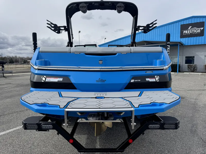 Slide: The Image of 2024 MasterCraft NXT23 boat, blue exterior, parked at Prestige dealership. - 5