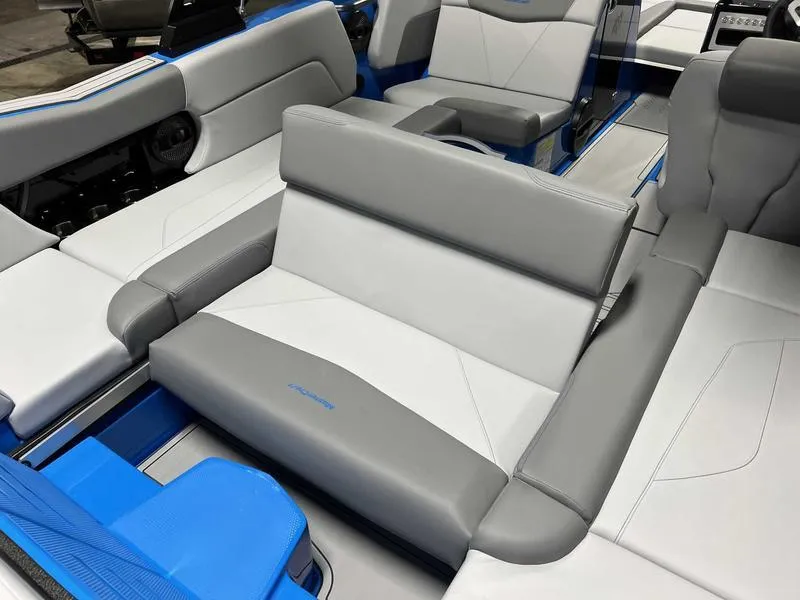 Slide: The Image of 2024 MasterCraft NXT23 boat interior with gray and blue seating. - 9