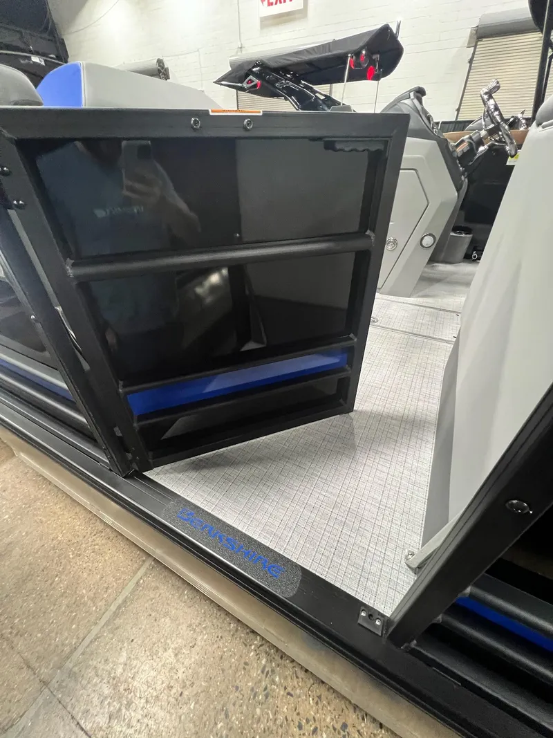 Slide: The Image of 2024 Berkshire 25RFC STS boat interior with open door and visible control panel. - 10
