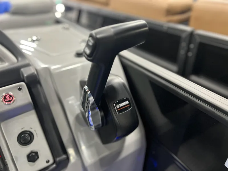 Slide: The Image of Close-up of the control panel and throttle of a 2024 Berkshire 25RFC STS boat. - 12