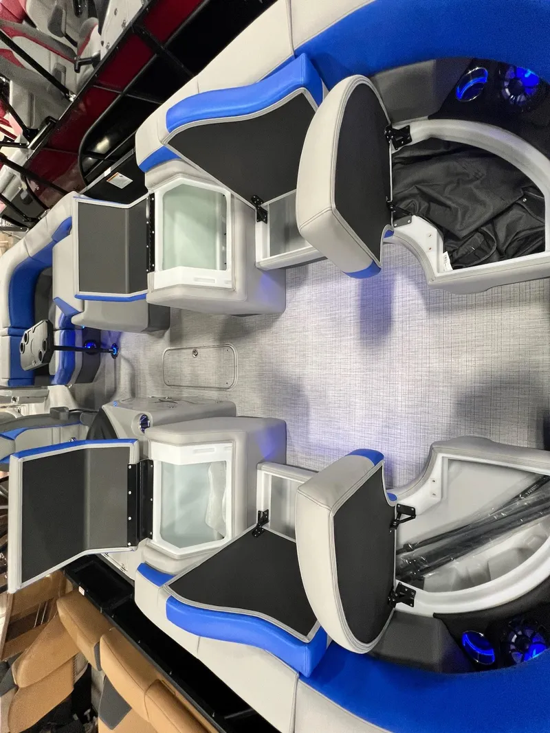 Slide: The Image of 2024 Berkshire 25RFC STS boat interior with open storage compartments and seating. - 14