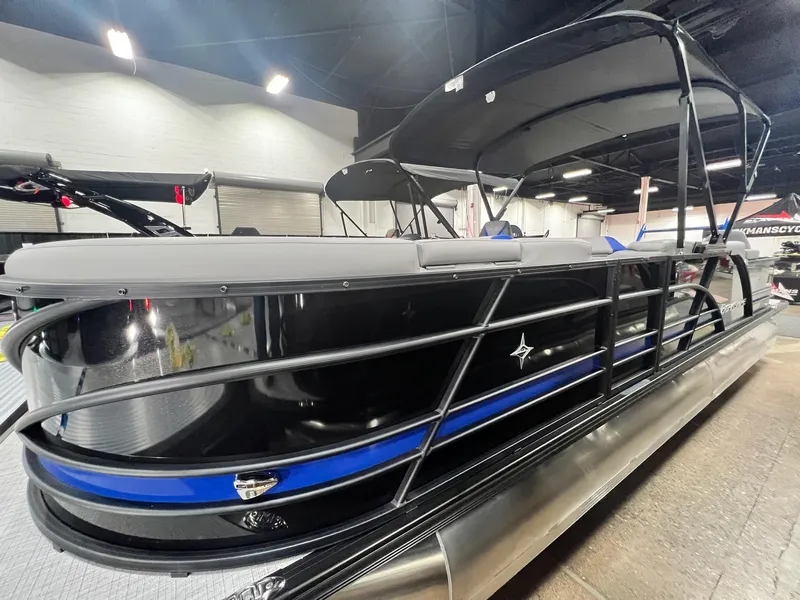 Slide: The Image of 2024 Berkshire 25RFC STS pontoon boat with black and blue accents in showroom. - 21