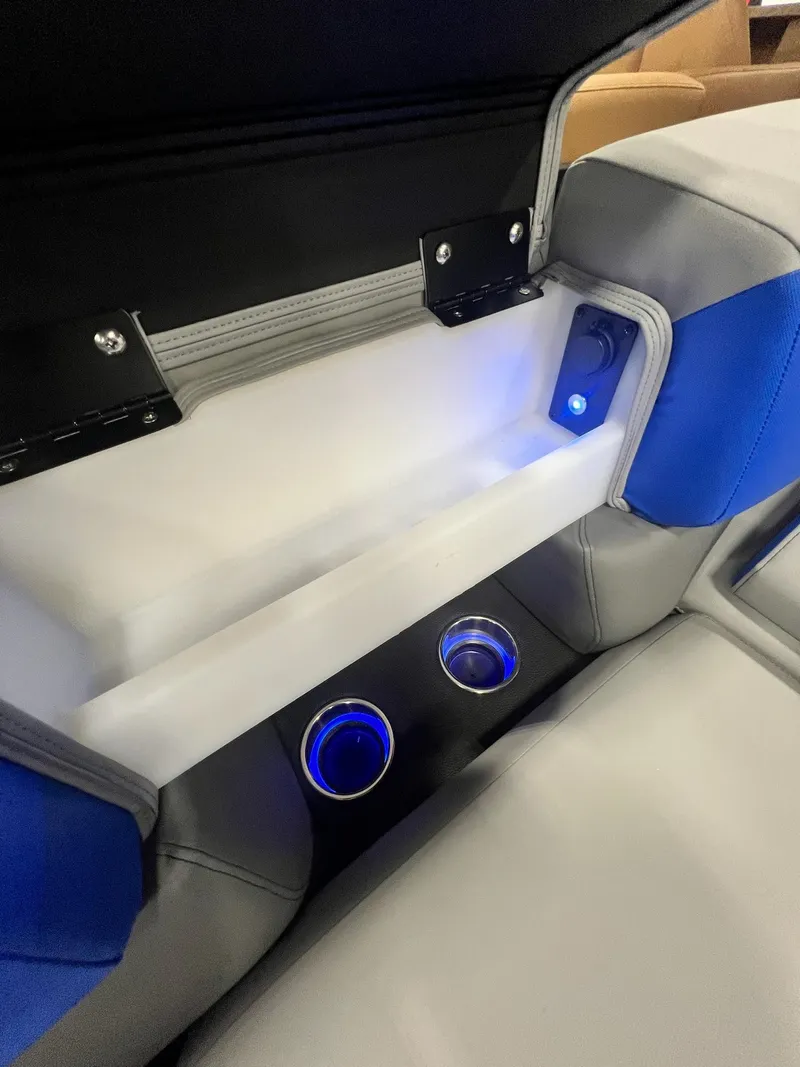 Slide: The Image of Interior storage compartment and illuminated cup holders in 2024 Berkshire 25RFC STS boat. - 25