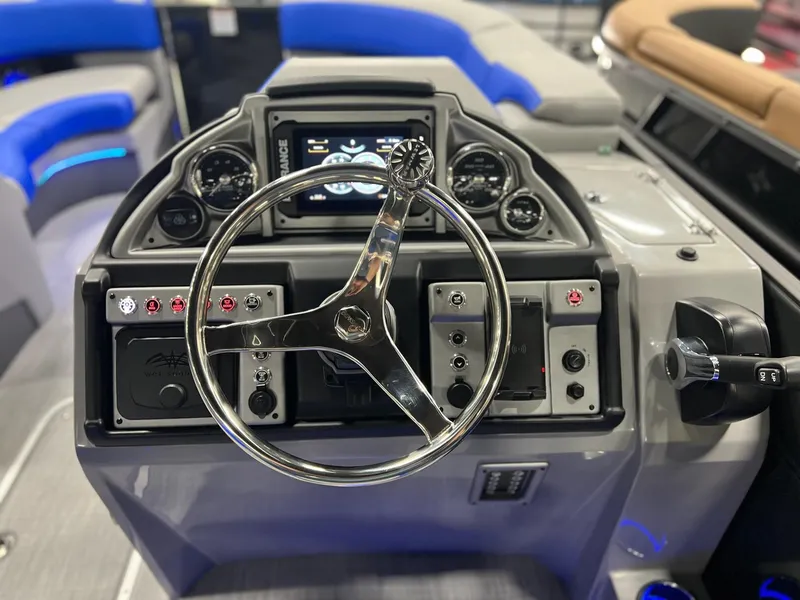 Slide: The Image of 2024 Berkshire 25RFC STS boat dashboard with steering wheel and control panel. - 28