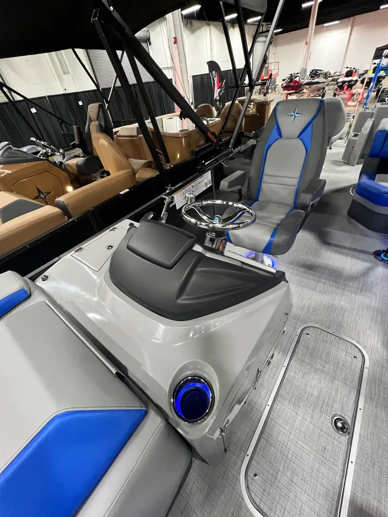 Slide: The Image of 2024 Berkshire 25RFC STS boat interior with steering console and seating. - 3