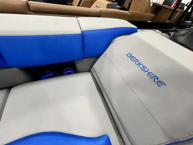 Slide: The Image of 2024 Berkshire 25RFC STS boat interior with blue and gray seating. - 30
