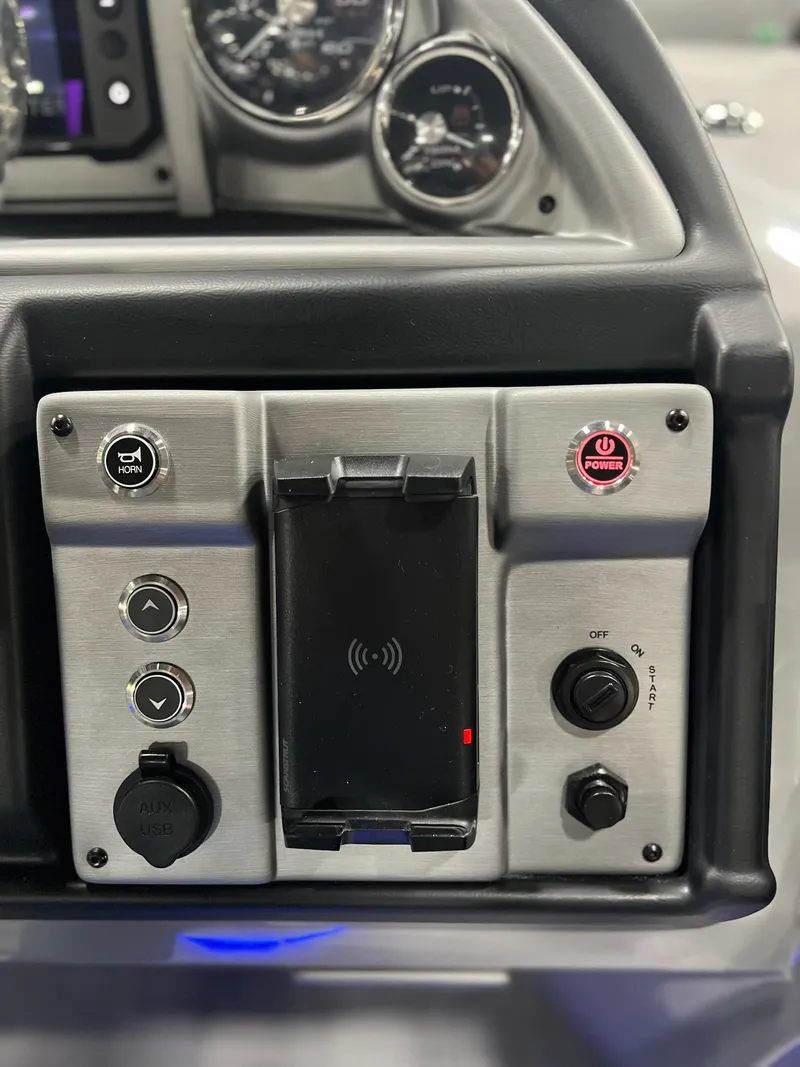 Slide: The Image of Control panel of a 2024 Berkshire 25RFC STS boat with gauges and buttons. - 35