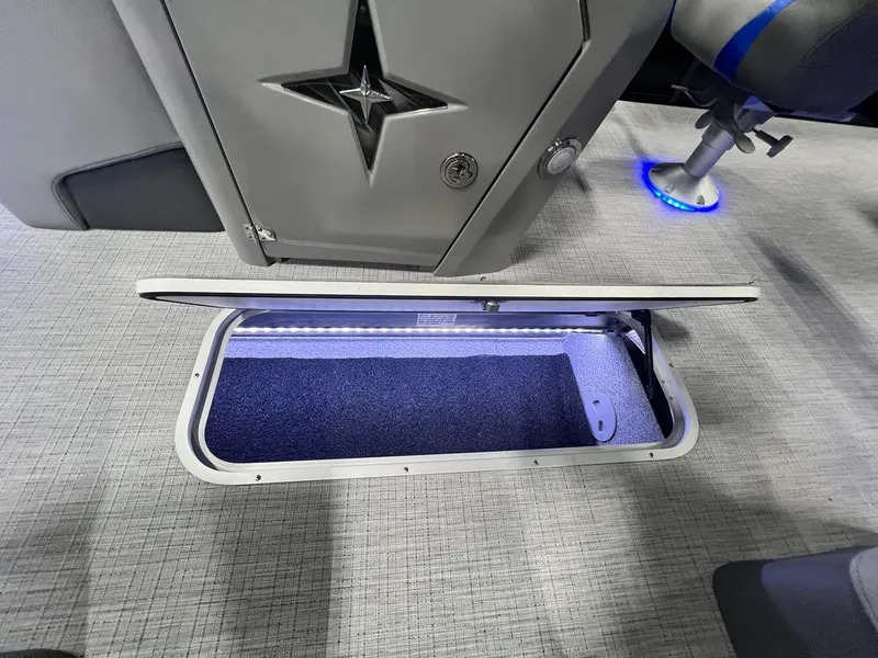 Slide: The Image of Open storage compartment in 2024 Berkshire 25RFC STS boat with LED lighting. - 36