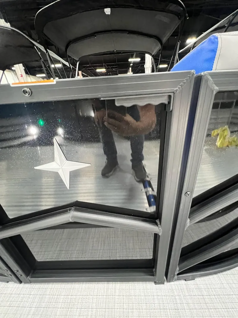 Slide: The Image of 2024 Berkshire 25RFC STS pontoon boat with black paneling and star emblem. - 4