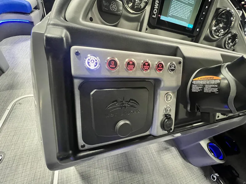 Slide: The Image of Control panel of 2024 Berkshire 25RFC STS pontoon boat with various switches and gauges. - 42