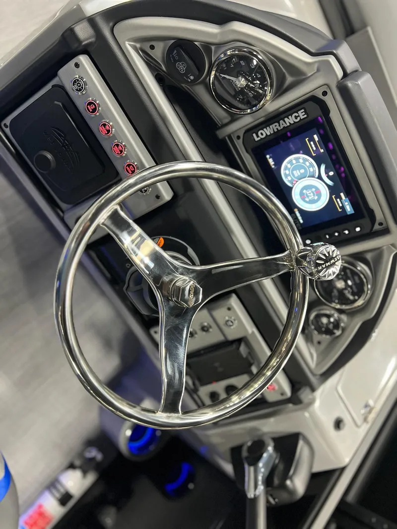 Slide: The Image of 2024 Berkshire 25RFC STS boat dashboard with Lowrance display and chrome steering wheel. - 9