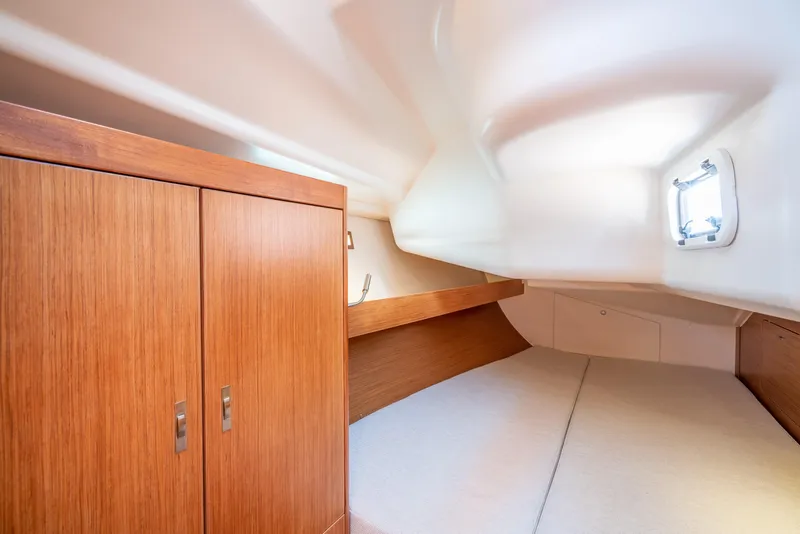 Slide: The Image of Interior cabin of 2016 Dehler 38 sailboat with wooden cabinets and cozy sleeping area. - 17
