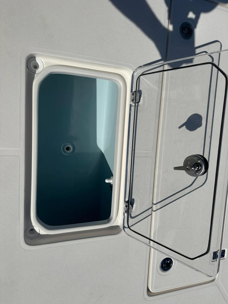 Slide: The Image of Open storage compartment on 2024 Sea Born FX25 Bay boat. - 11